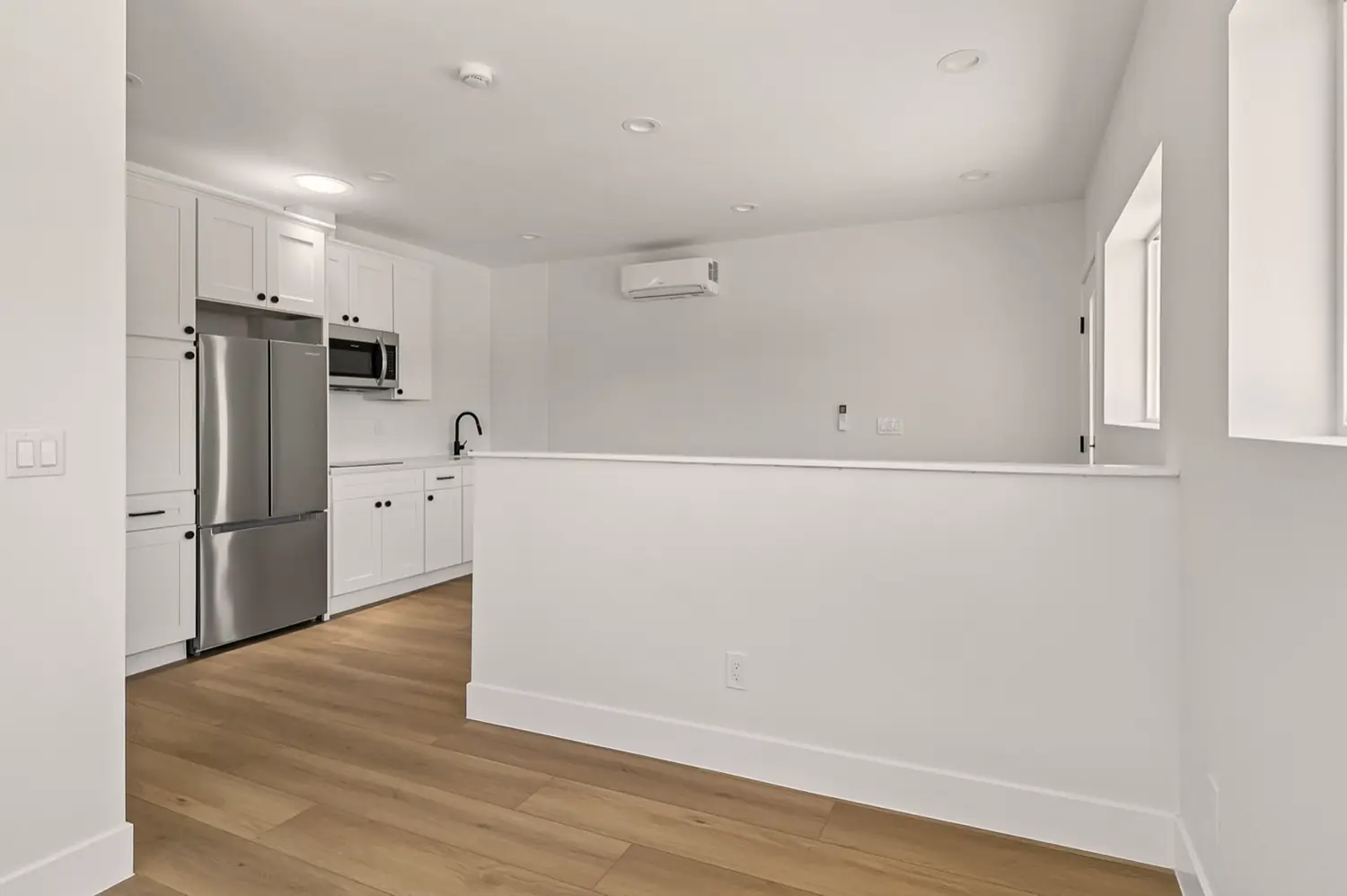 49th Street garage conversion — living area with pony wall