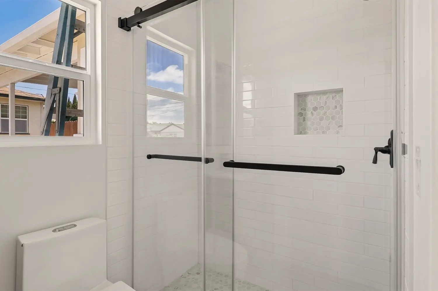 49th Street garage conversion — tiled shower with niche